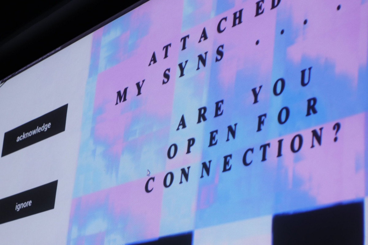 Digital art display with text 'ATTACHED MY SYNS... ARE YOU OPEN FOR CONNECTION?' with 'acknowledge' and 'ignore' buttons, against a background with pink and blue glitch art patterns.