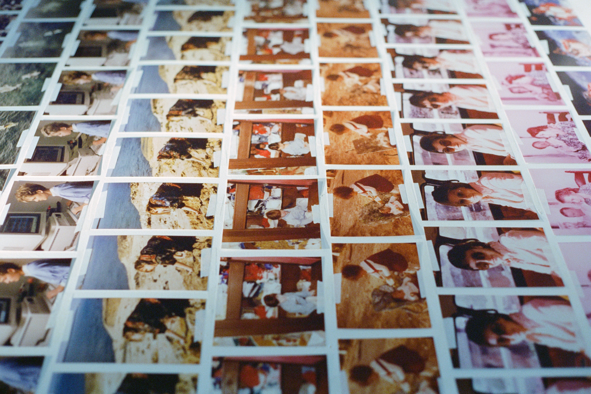 Rows of family photographs are methodically arranged on a flat surface. Each row consists of repeating images, capturing intimate moments and outdoor scenes